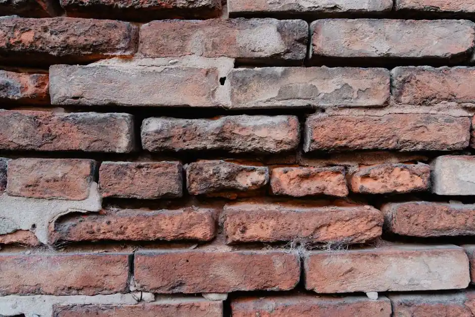 Detailed close-up view of an aged red brick wall showcasing texture and rustic appearance.